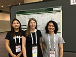 3 People in front of a research poster